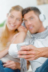 Couple sharing headphones