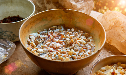 Semi-precious stones lying in the bowl and on the table