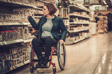 Fototapeta na wymiar Disabled woman in a wheelchair in a department store