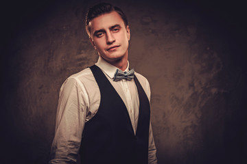 Sharp dressed man wearing waistcoat and bow tie