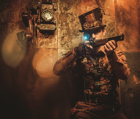 steampunk style man with various mechanical devices on vintage steampunk background