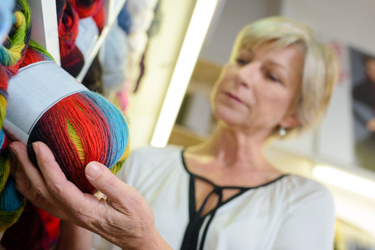 Woman choosing ball of wool