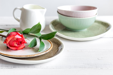 ceramic tableware with flowers on white background