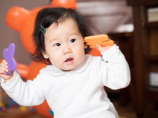 Fototapeta premium baby girl playing toy at home