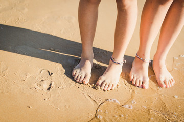 children's feet on sand