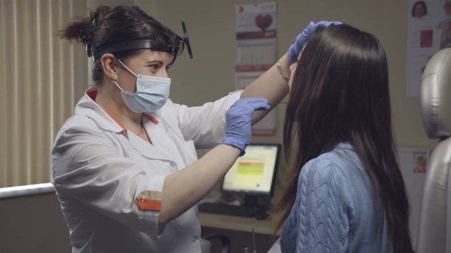 Otolaryngologist examines a patient in clinic