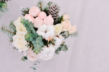 Tender wedding bouquet of roses, cone and cotton, closeup