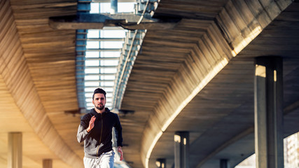 Man Runner Under Bridge in the City