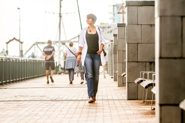 outdoor portrait of young happy smiling woman on urban city background