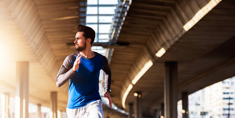 Man Runner Under Bridge in the City