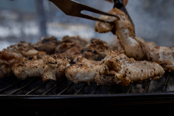 Delicious chicken wings on garden grill