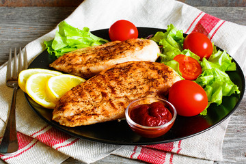 Grilled chicken breast fillet served with fresh vegetables