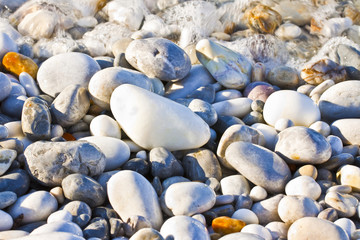 Background with white and gray stones softly rounded and washed from sea water