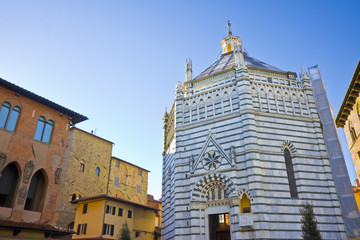 Saint John's baptistery in Pistoia city built in the year 1303 with an octagonal base - On the left the Episcopal Palace (Tuscany - Italy)