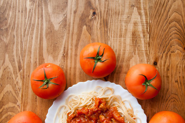 Italian spaghetti on a wooden table with text space