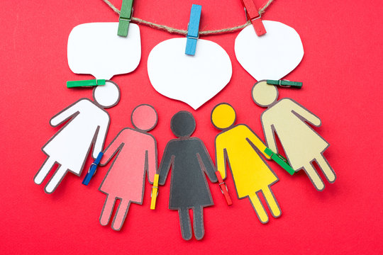 Paper Group of Women of different races holding hands with paperclips - Powered by Adobe