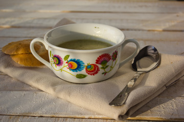 polish soup made of potatoes, in bowls with folk ornaments