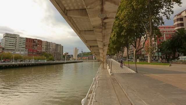View on Nervion river under Zubizuri bridge, beautiful cityscape of Bilbao