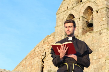 Handsome young priest close up with copy space