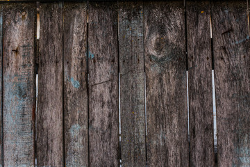 Wooden fence with boards with peeling paint
