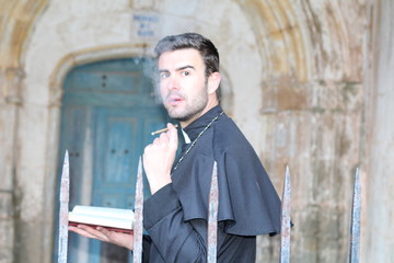 Priest smoking while taking a break