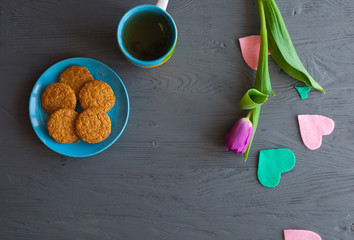 Mother's Day, woman's day. tulips ,presents ,tea and sweets on wooden background