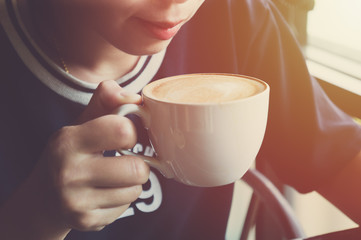 beautiful Asian woman drinking coffee in coffee shop