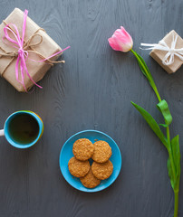 Mother's Day, woman's day. tulips ,presents ,tea and sweets on wooden background