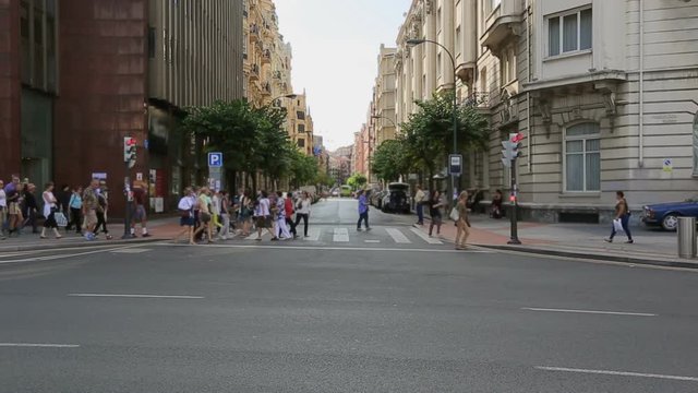 Pedestrians crossing the road in Bilbao city center, sightseeing in Europe