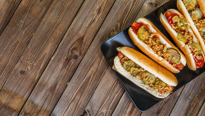 American hot dog with pickles,onions, ketchup and mustard