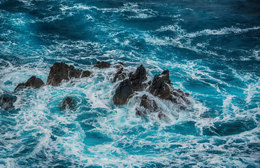 Blue raging waves crashing on the rocks in tne Atlantic ocean