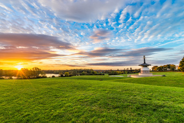 Fototapeta premium Panorama of Peace Pagoda temple at sunrise in Willen Park, Milton Keynes, UK