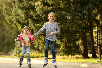 Cute girls on roller skates in park