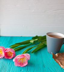 Mother's Day, woman's day. tulips ,presents ,tea and sweets on wooden background