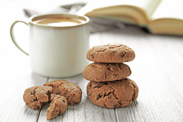 Delicious homemade cookies and cup of coffee on wooden table
