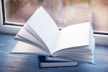 Opened book on windowsill, closeup