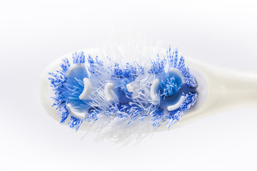 Close up of an old toothbrush on white background