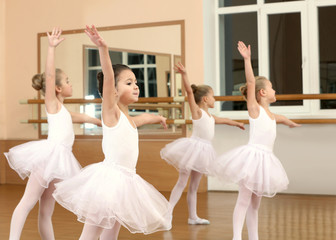 Group of beautiful little girls practicing ballet at class © Africa Studio