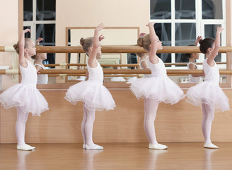 Obraz premium Group of beautiful little girls practicing ballet at class