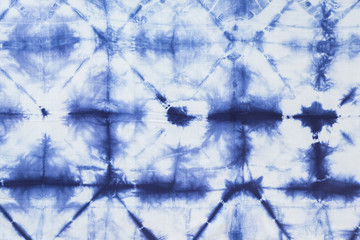 Pattern of blue dye on cotton cloth, Dyed indigo fabric background and textured