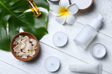 Natural cosmetics and leaf on wooden background