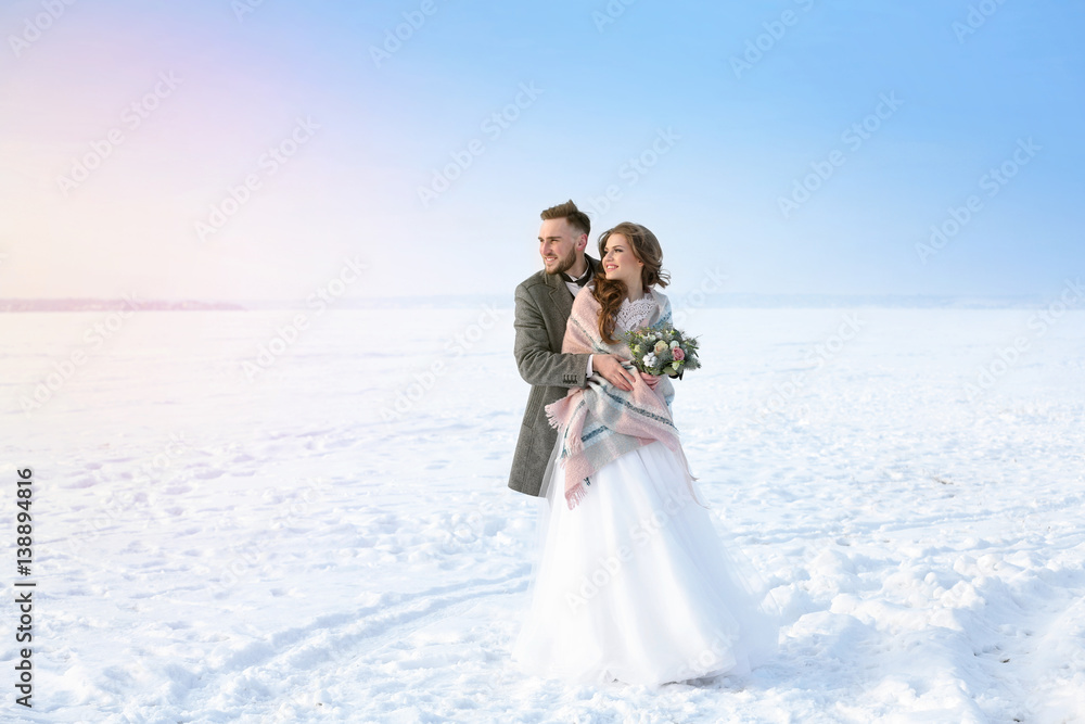 Wall mural happy wedding couple outdoors on winter day