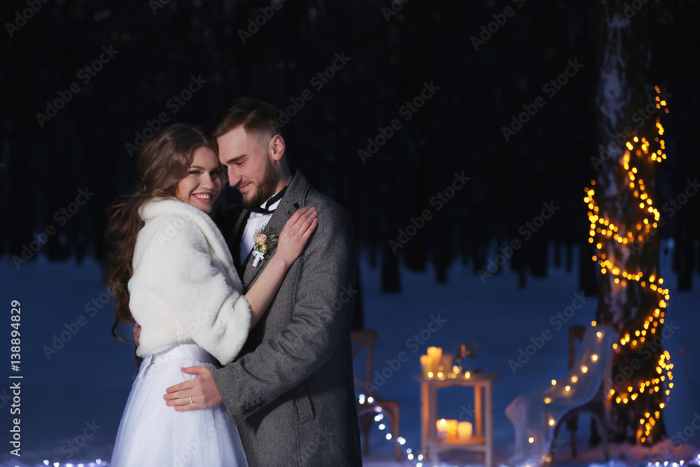 Wall mural Beautiful winter wedding outdoors in evening