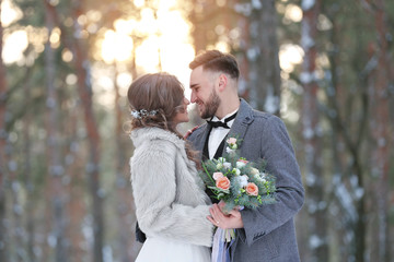 Happy wedding couple outdoors on winter day