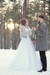 Fototapeta na wymiar Happy wedding couple outdoors on winter day