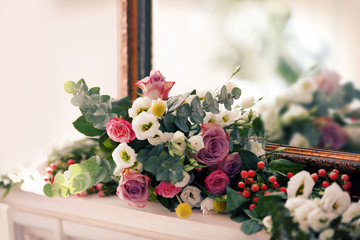 Beautiful composition with fresh flowers on mantelpiece