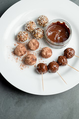 Melted Chocolate Dip and Various Protein Energy Balls on Plate
