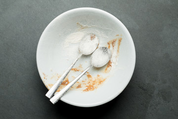 Pair of Flour Covered Spoons in Dirty Bowl