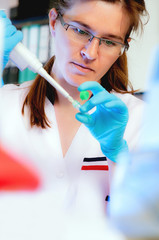 Portrait of a scientist taking aliquote of an enzyme in modern lab