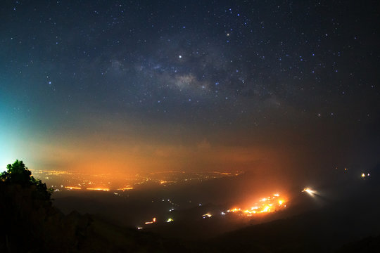 Milky way galaxy over foggy mountains at Phutabberk Phetchabun in Thailand. Long exposure photograph.with grain
